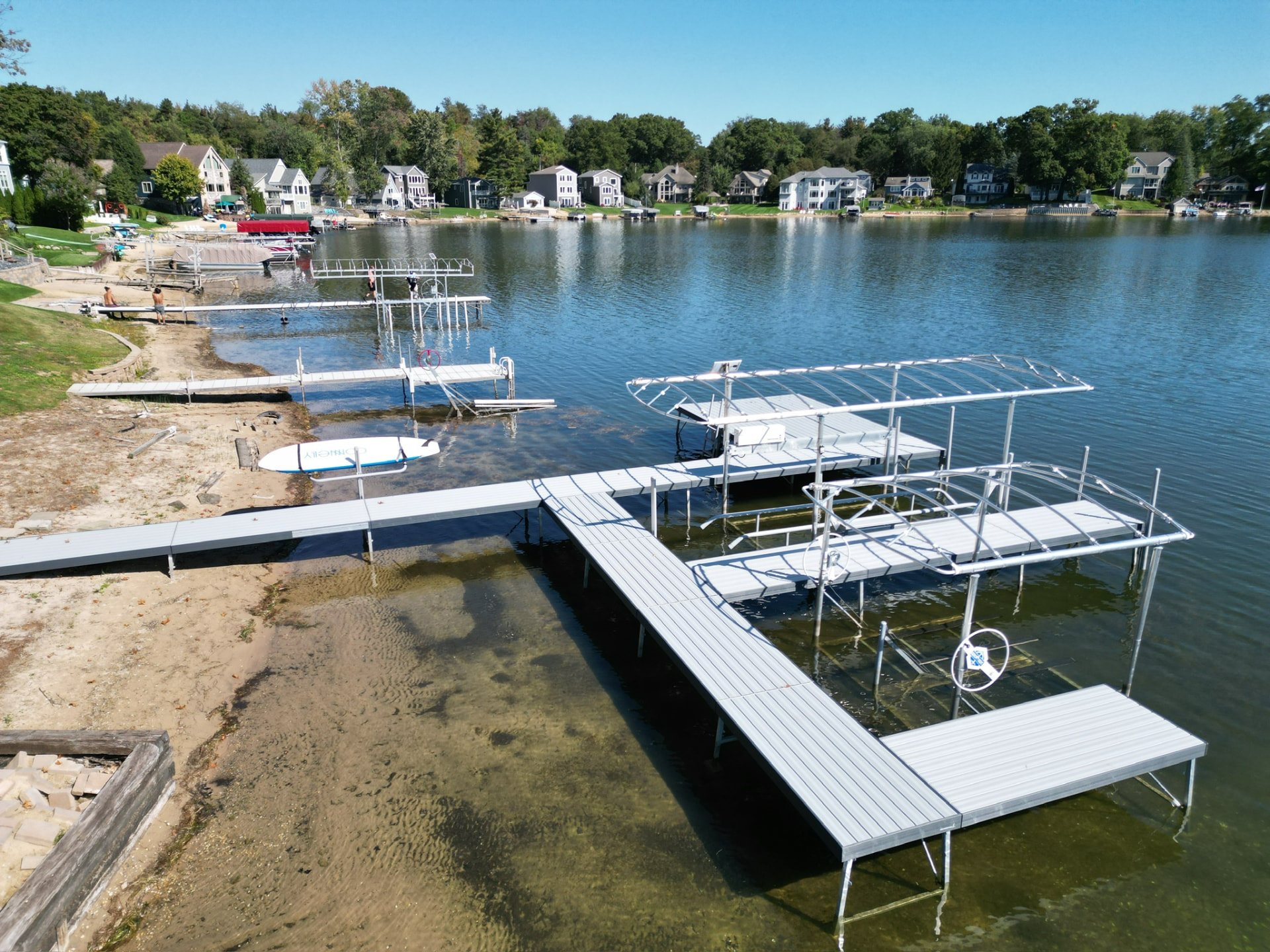 Aluminum sectional dock and boat lift installed on a Michigan lake shoreline