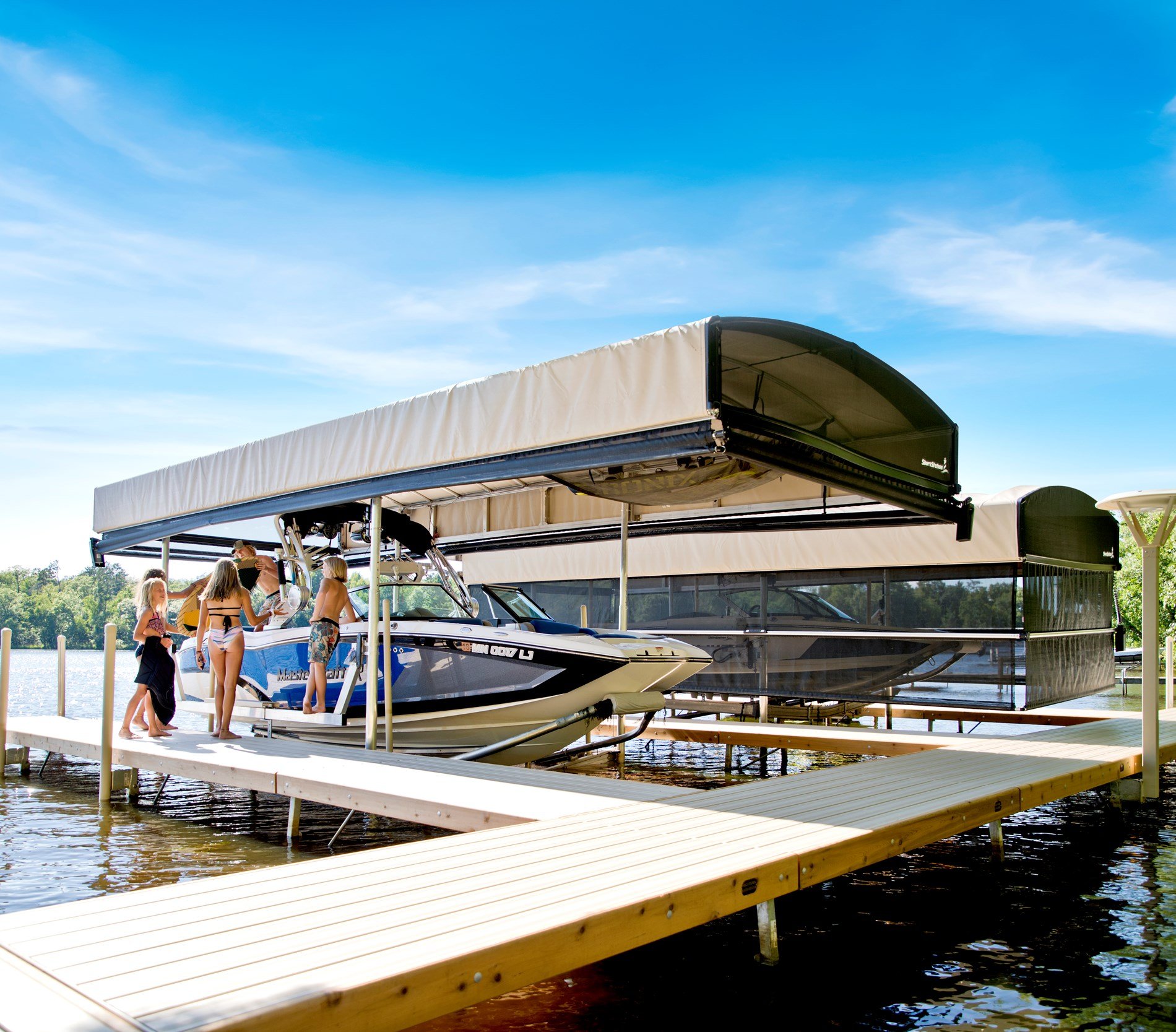Aluminum boat lift installed alongside a residential waterfront dock