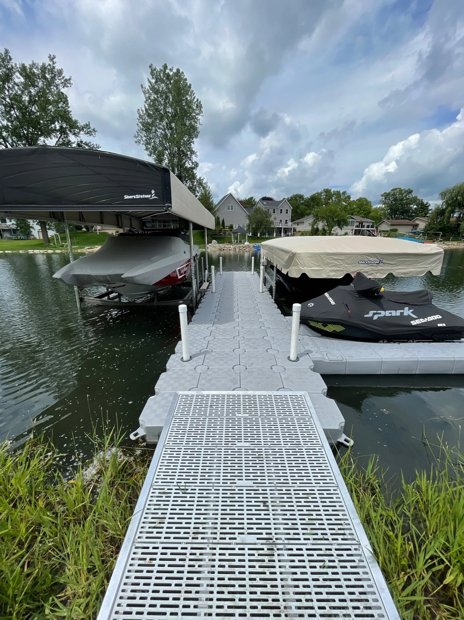 Modular floating dock installed on a lake with a soft, mucky bottom