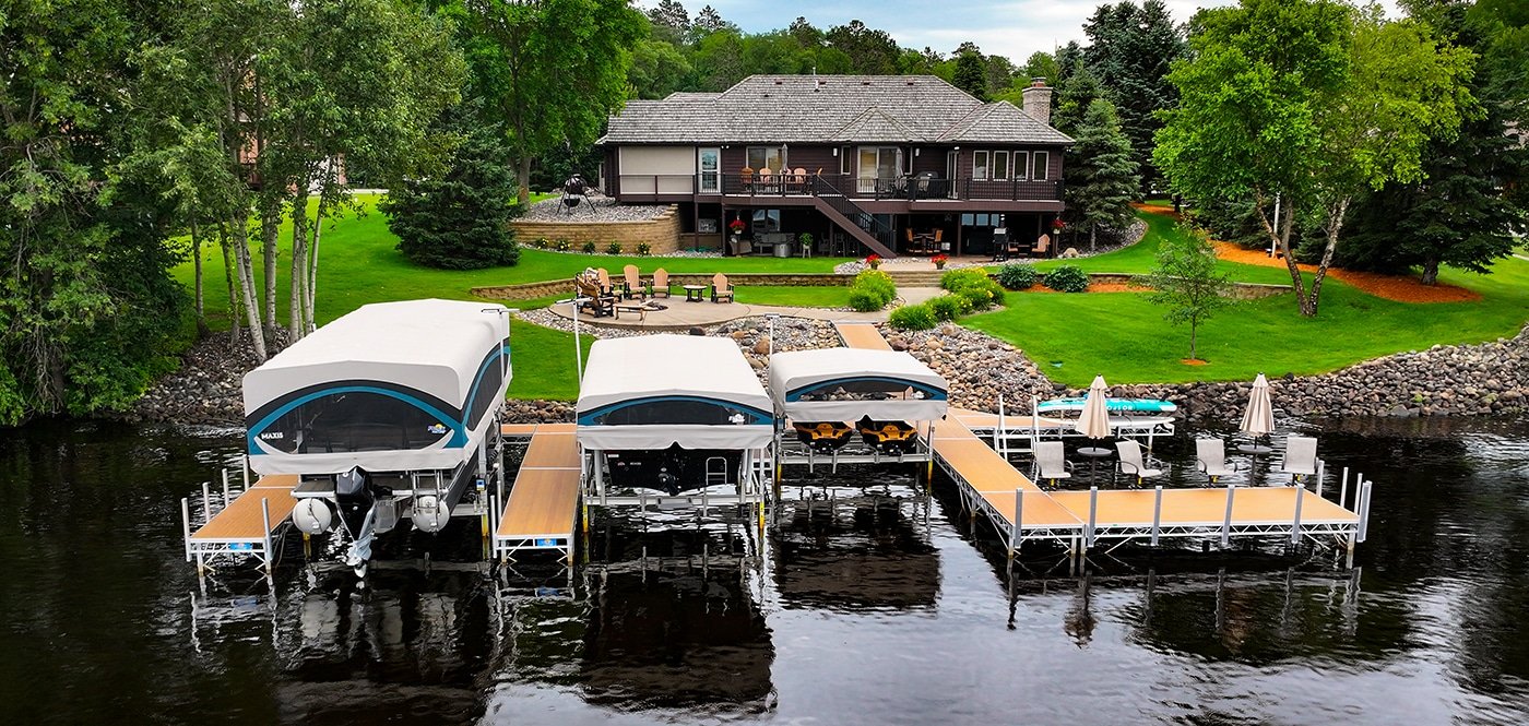 FLOE aluminum dock with chestnut-toned decking extending over calm water
