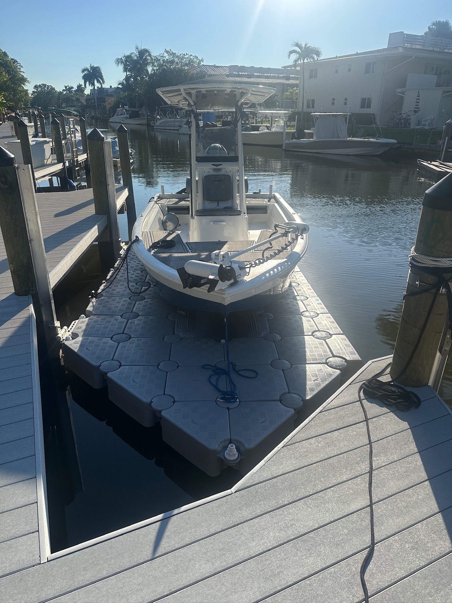 Compatible center-console boat supported above the water on a CanDock drive-on system
