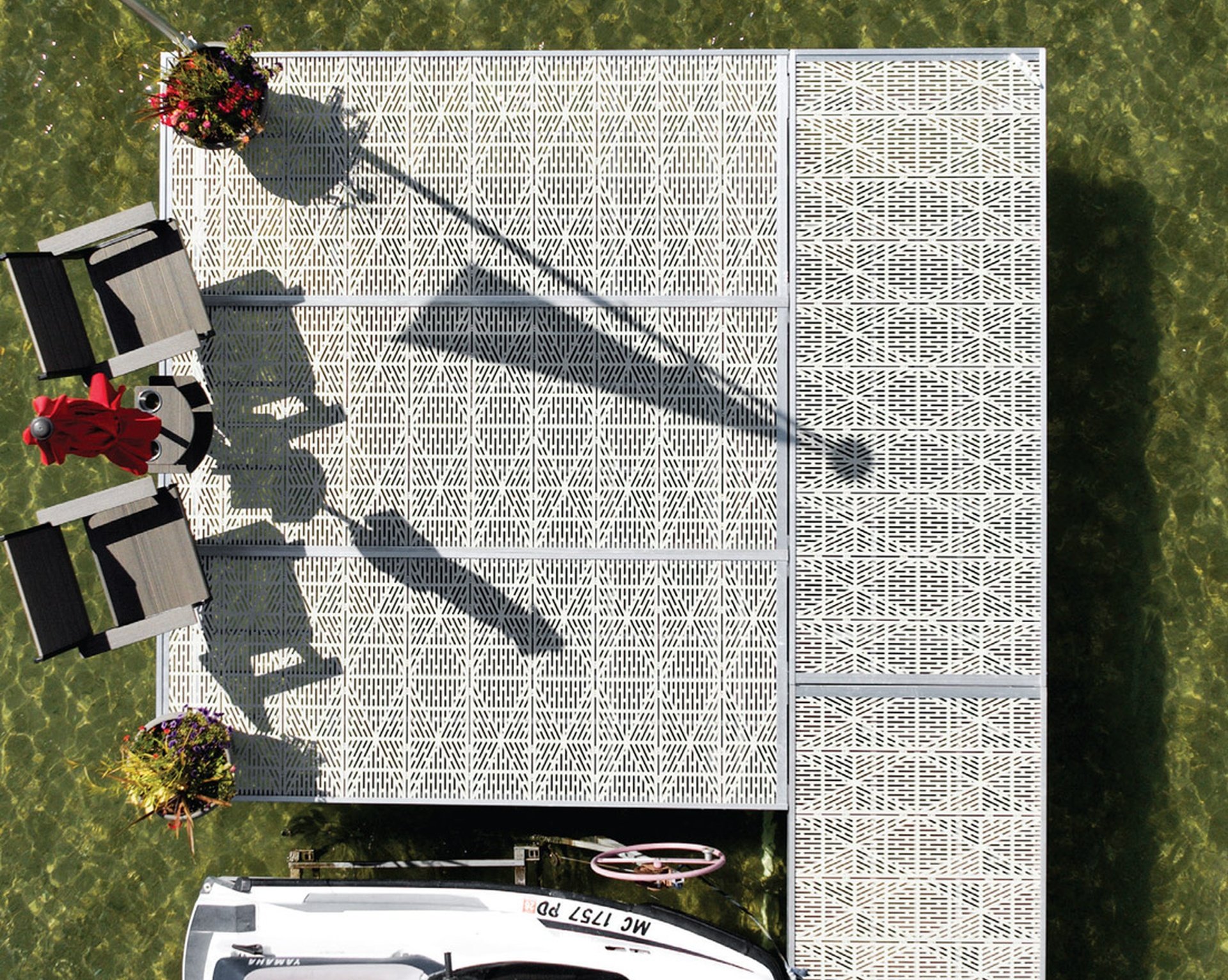Aluminum dock with flow-through diamond decking over clear lake water