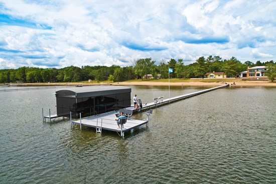 Aluminum sectional dock with a walkway and a canopied boat lift on a Michigan lake