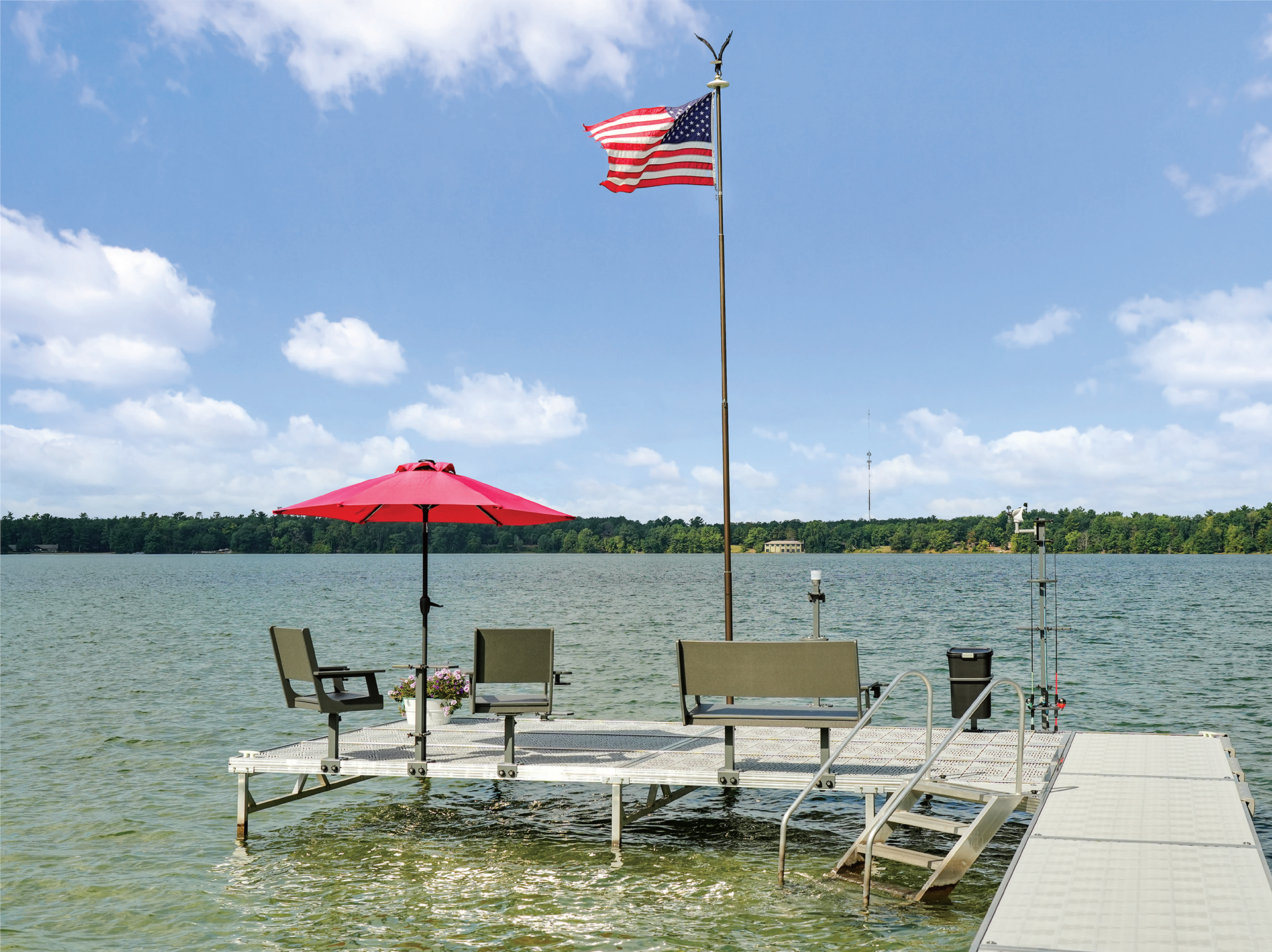 Poly dock furniture and accessories arranged on a lakefront dock