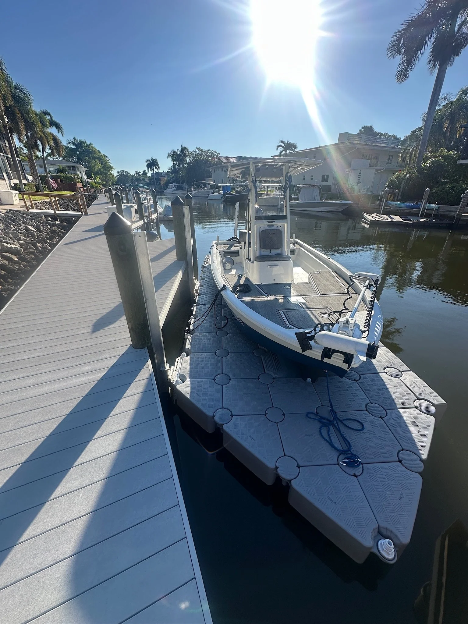 Modular HDPE floating dock installed along a Florida canal seawall