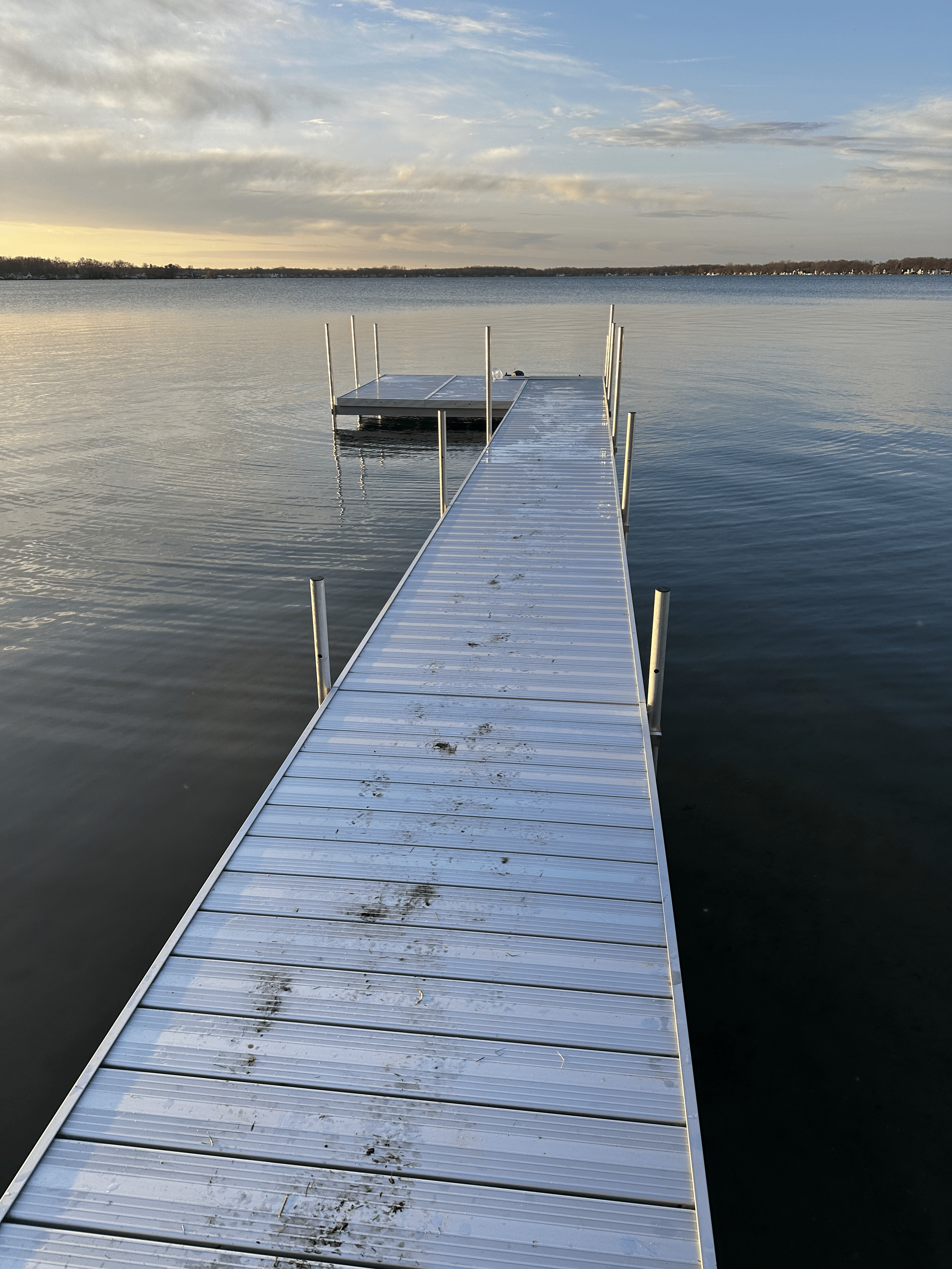 Poorly fitted dock sitting unevenly on a Michigan lake shoreline